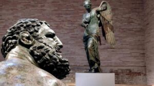 Statue romane con pugile in primo piano e figura sullo sfondo, simbolo di equilibrio tra forza e controllo nelle operazioni immobiliari
